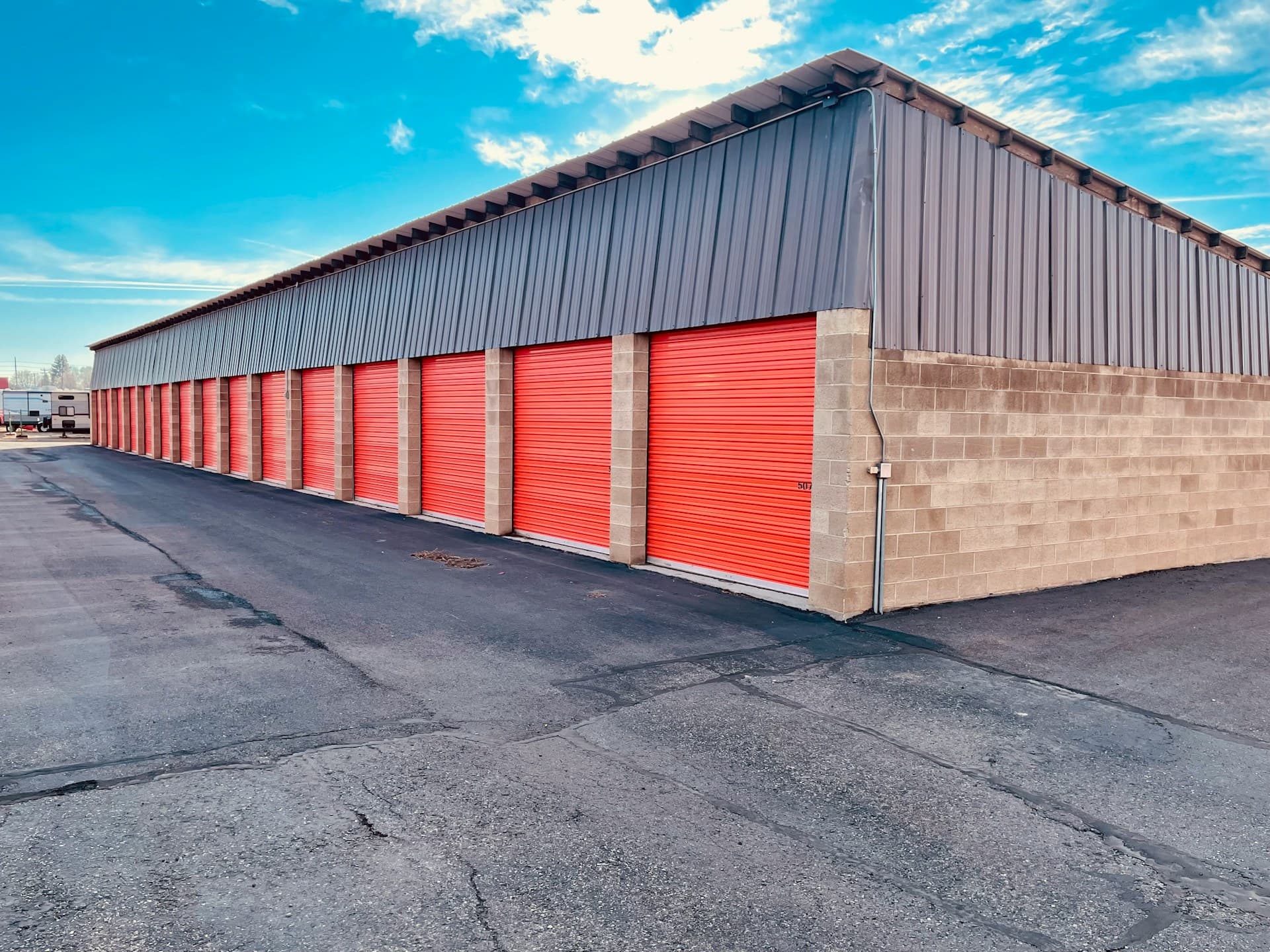 Row of storage units with bright orange doors
